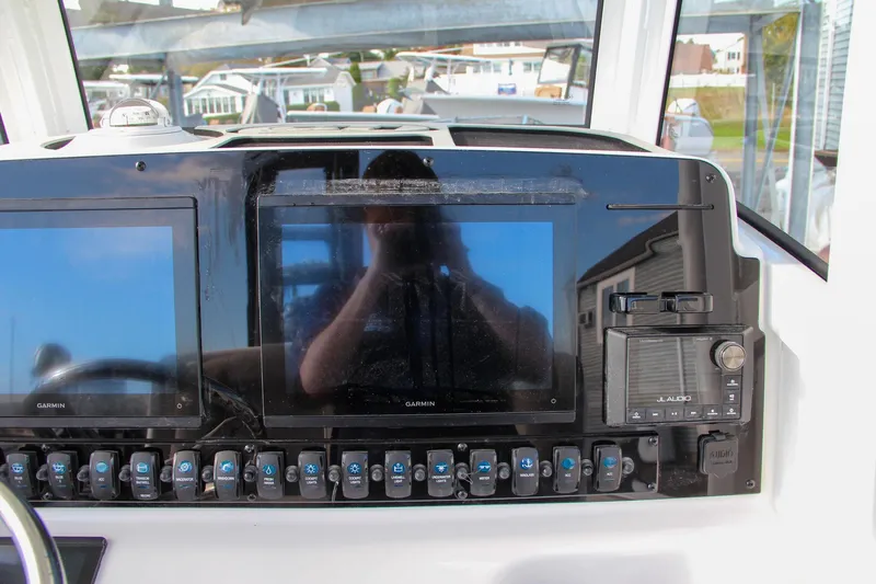 Slide: The Image of Dashboard of 2025 Sea Hunt Ultra 265 SE with dual Garmin displays and controls. - 46