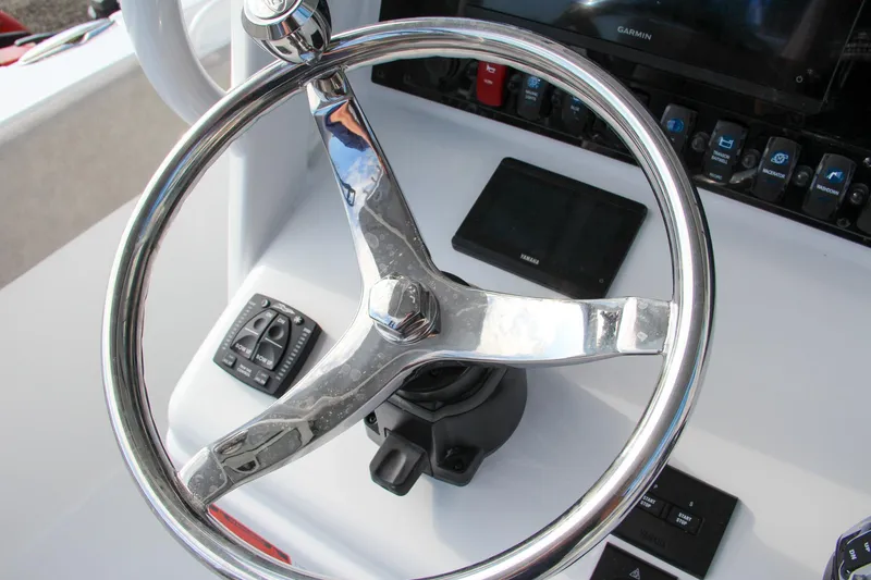 Slide: The Image of Steering wheel of 2025 Sea Hunt Ultra 265 SE boat with control panel. - 47