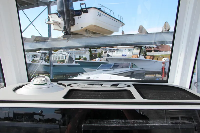 Slide: The Image of Interior view of 2025 Sea Hunt Ultra 265 SE boat dashboard at marina. - 49