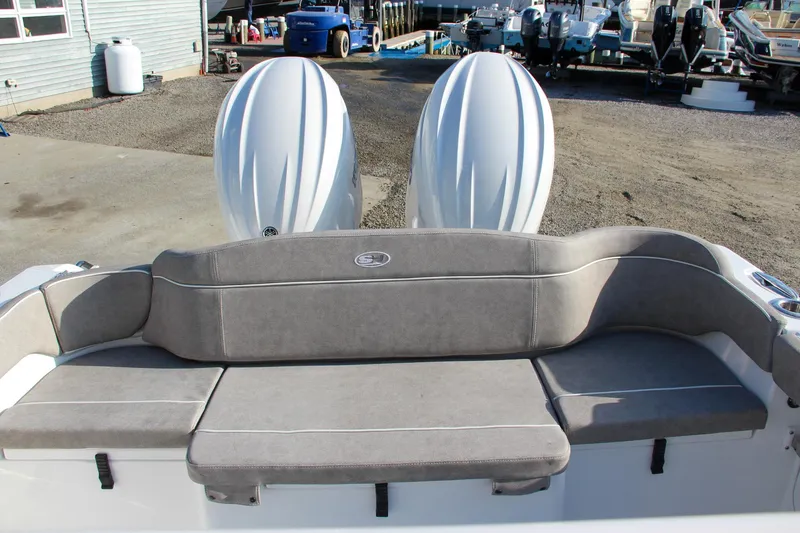 Slide: The Image of 2025 Sea Hunt Ultra 265 SE boat with dual engines and cushioned seating. - 5