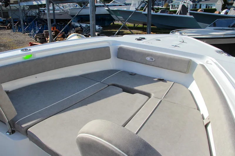 Slide: The Image of 2025 Sea Hunt Ultra 265 SE boat interior with cushioned seating and spacious deck. - 7