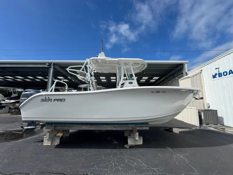 Slide: The Image of 2022 Sea Pro 259 Center Console boat on display in a marina. - 17