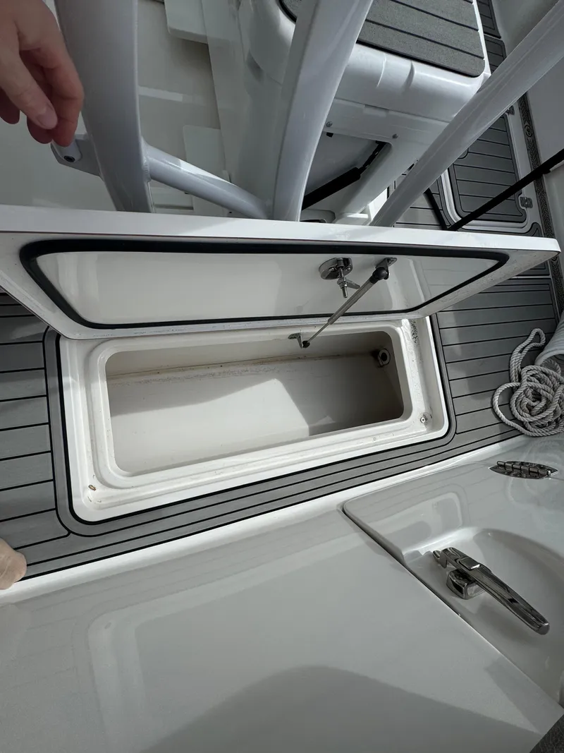 Slide: The Image of Open storage compartment on 2022 Sea Pro 259 Center Console boat. - 20