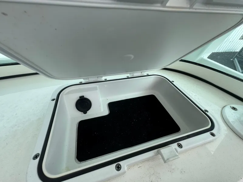 Slide: The Image of Open storage compartment on 2022 Sea Pro 259 Center Console boat. - 21