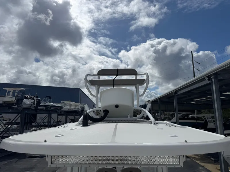 Slide: The Image of 2022 Sea Pro 259 Center Console boat under cloudy sky at marina. - 25