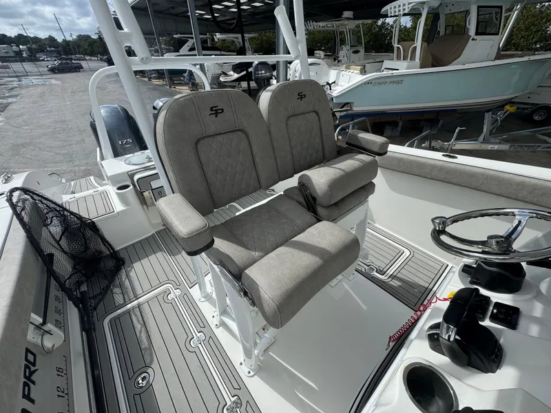 Slide: The Image of 2022 Sea Pro 259 Center Console boat interior with dual seats and steering wheel. - 27
