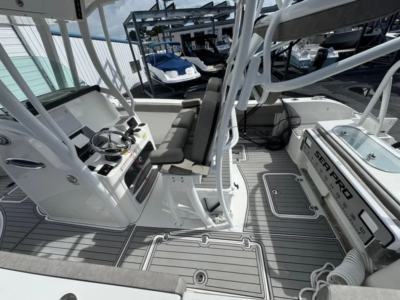 Slide: The Image of 2022 Sea Pro 259 Center Console boat interior with helm and seating. - 33