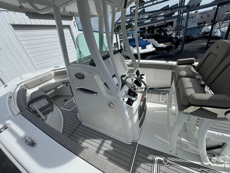 Slide: The Image of 2022 Sea Pro 259 Center Console boat interior with helm and seating. - 34
