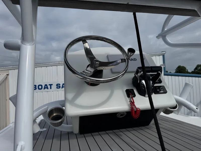 Slide: The Image of 2022 Sea Pro 259 Center Console helm with steering wheel and controls. - 37