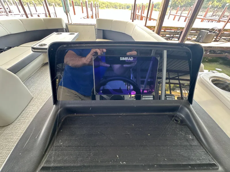 Slide: The Image of 2024 Harris FloteBote HCX 23 dashboard with Simrad display on a pontoon boat. - 12