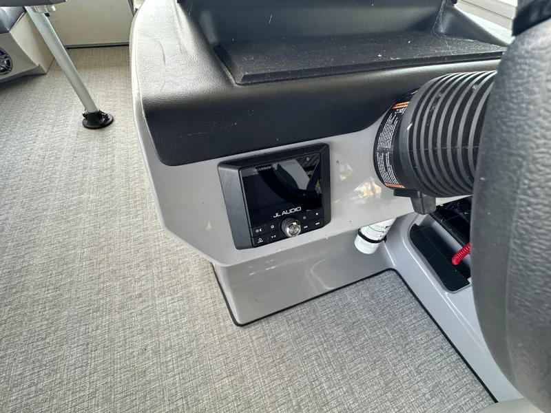 Slide: The Image of 2024 Harris FloteBote HCX 23 boat dashboard with JL Audio system. - 13