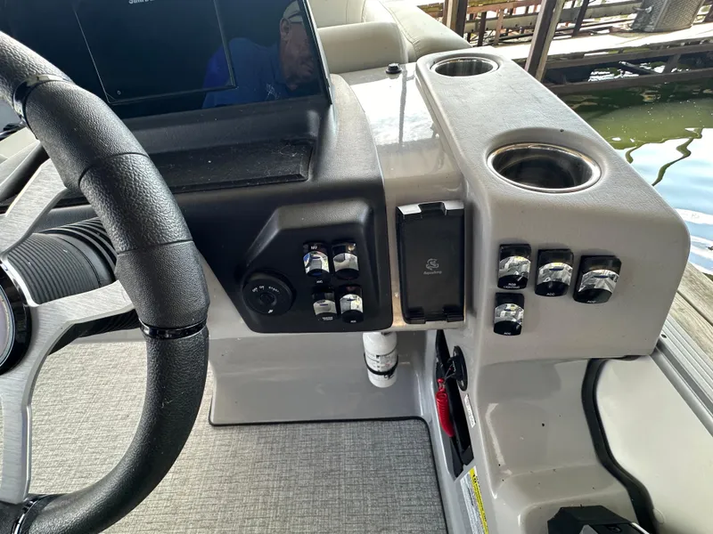 Slide: The Image of 2024 Harris FloteBote HCX 23 dashboard with steering wheel and control panel. - 14