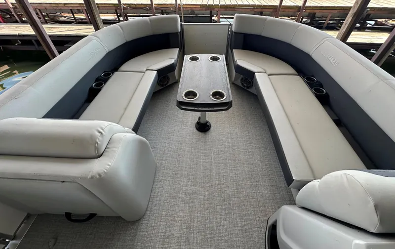 Slide: The Image of 2024 Harris FloteBote HCX 23 pontoon boat interior with spacious seating and table. - 20