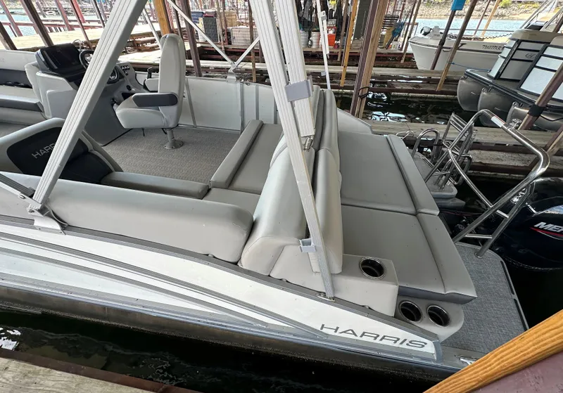 Slide: The Image of 2024 Harris FloteBote HCX 23 pontoon boat with sleek seating and modern design. - 3