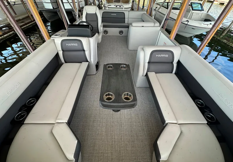 Slide: The Image of 2024 Harris FloteBote HCX 23 pontoon boat interior with spacious seating and table. - 4
