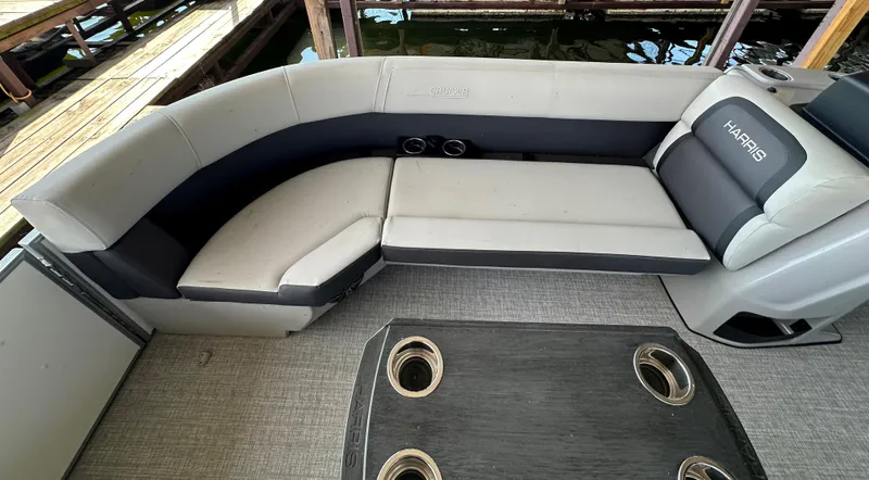 Slide: The Image of 2024 Harris FloteBote HCX 23 pontoon boat interior with plush seating and cup holders. - 6