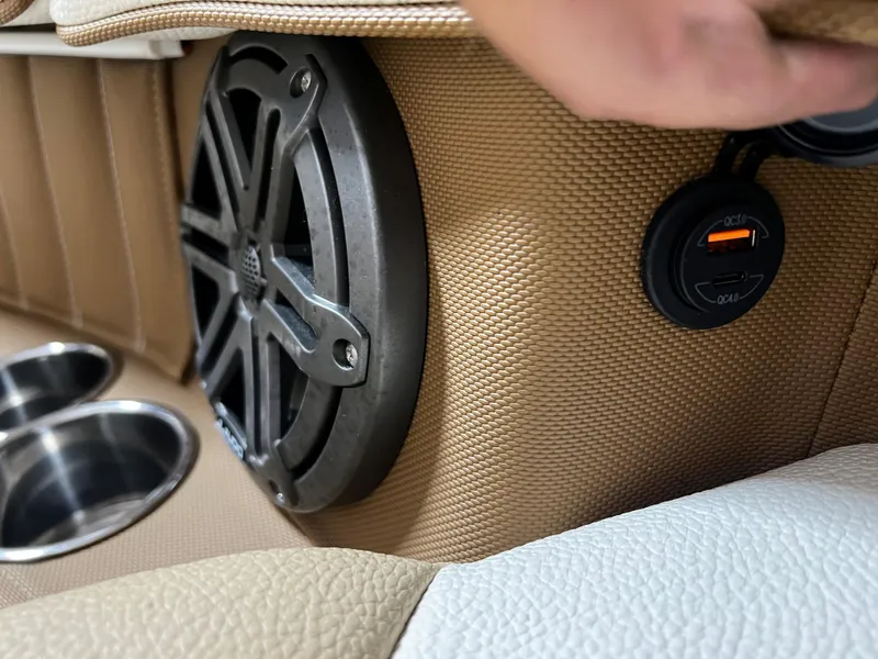 Slide: The Image of Cobalt 23SC 2021 boat interior with speaker, USB port, and cup holders. - 11