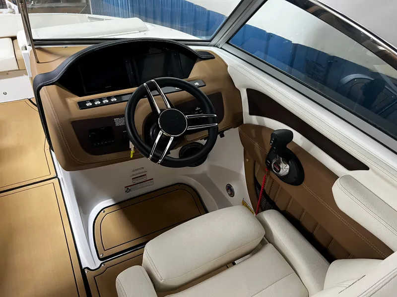 Slide: The Image of 2021 Cobalt 23SC boat interior with steering wheel and control panel. - 13