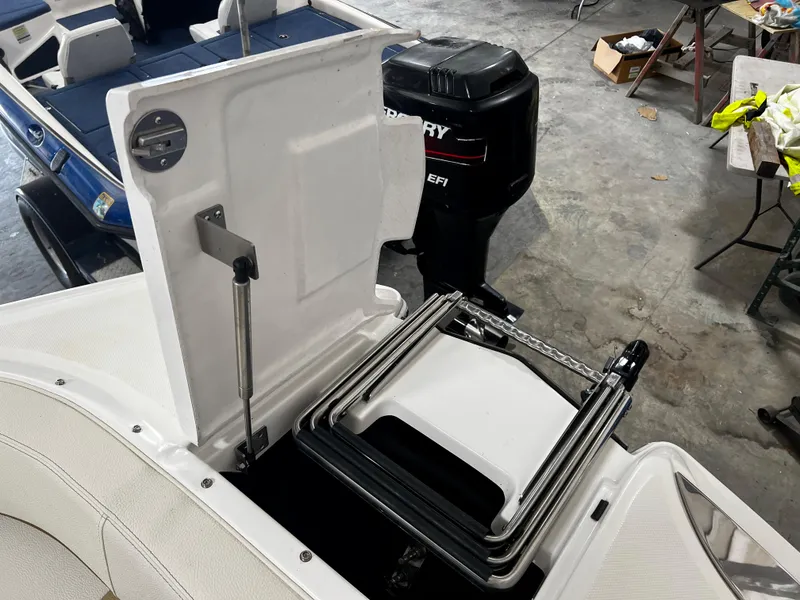 Slide: The Image of 2021 Cobalt 23SC boat with foldable ladder and Mercury outboard motor in a garage setting. - 8