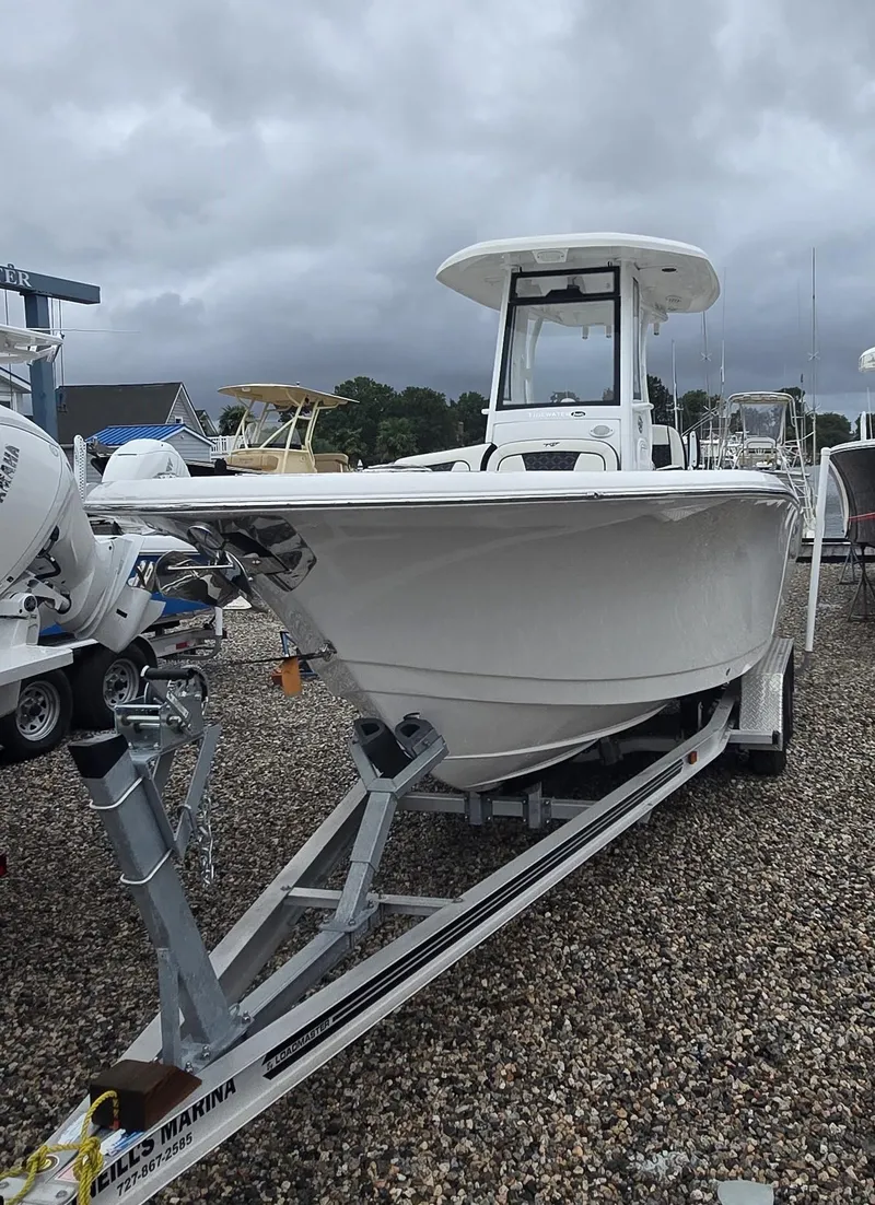 Slide: The Image of 2023 Tidewater 232 SS boat on trailer, overcast sky background. - 0