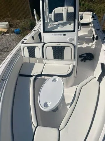 Slide: The Image of 2023 Tidewater 232 SS boat interior with white seating and console. - 1