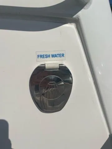 Slide: The Image of 2023 Tidewater 232 SS boat fresh water access panel. - 11
