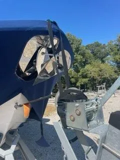 Slide: The Image of 2023 Tidewater 232 SS boat on trailer, secured with straps, outdoors. - 14