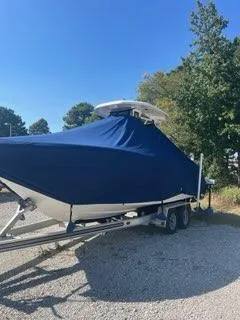 Slide: The Image of 2023 Tidewater 232 SS boat covered, parked on a trailer, outdoors. - 15