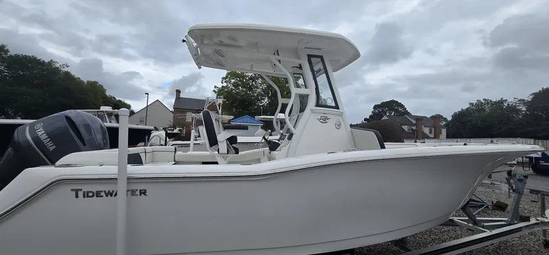 Slide: The Image of 2023 Tidewater 232 SS boat on trailer, side view, overcast sky. - 22