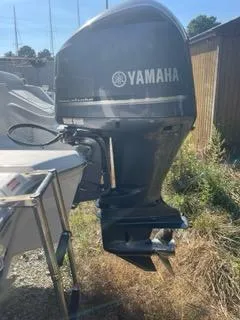 Slide: The Image of 2023 Tidewater 232 SS boat with Yamaha outboard motor in a sunny outdoor setting. - 23