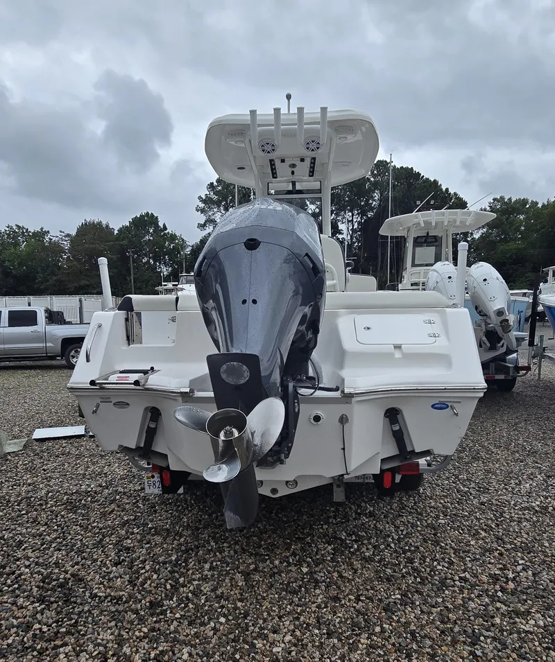 Slide: The Image of 2023 Tidewater 232 SS boat with outboard motor, parked on gravel lot. - 24