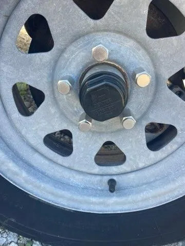 Slide: The Image of Close-up of a 2023 Tidewater 232 SS wheel with lug nuts and hub. - 25
