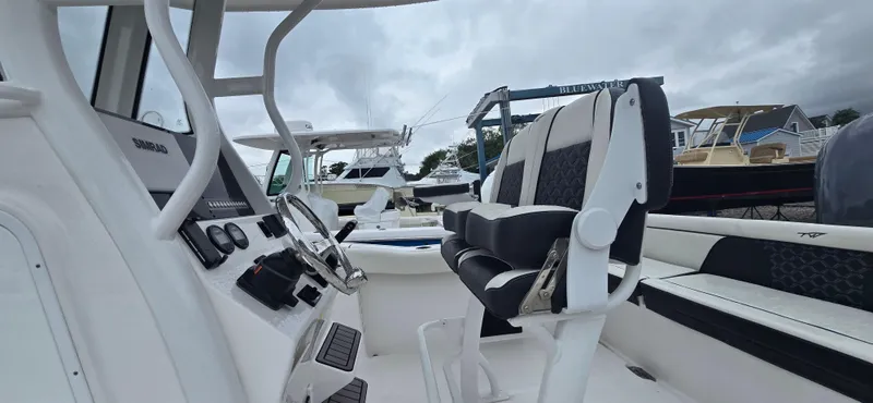 Slide: The Image of 2023 Tidewater 232 SS boat interior with modern seating and controls. - 4
