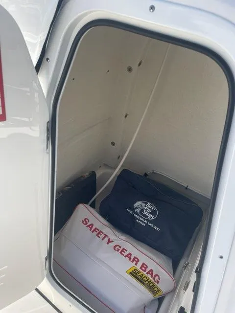 Slide: The Image of Storage compartment of 2023 Tidewater 232 SS with safety gear bags. - 9