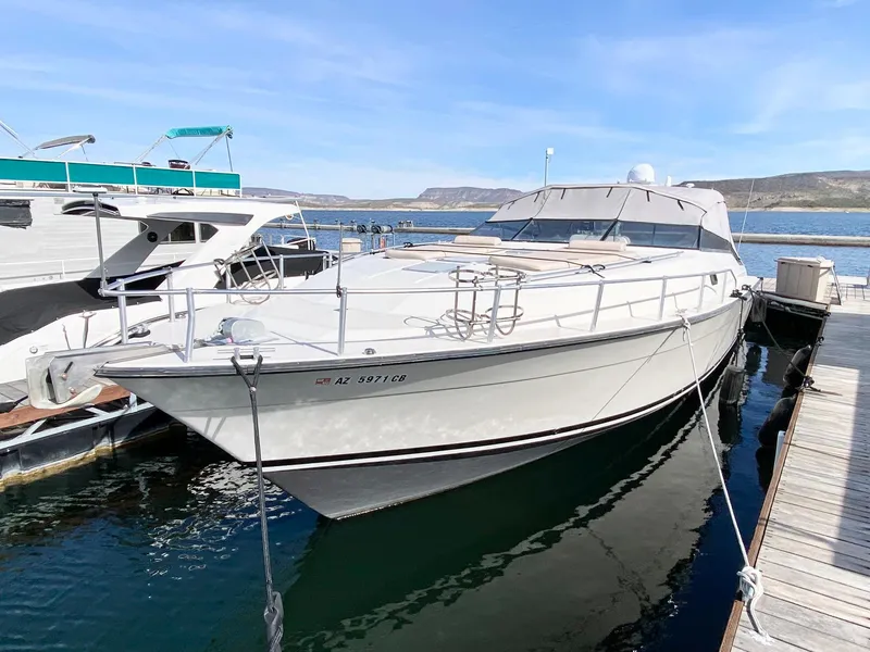 Slide: The Image of 1989 Mainship 39 Mediterranean Express docked at marina, clear sky, calm water. - 11