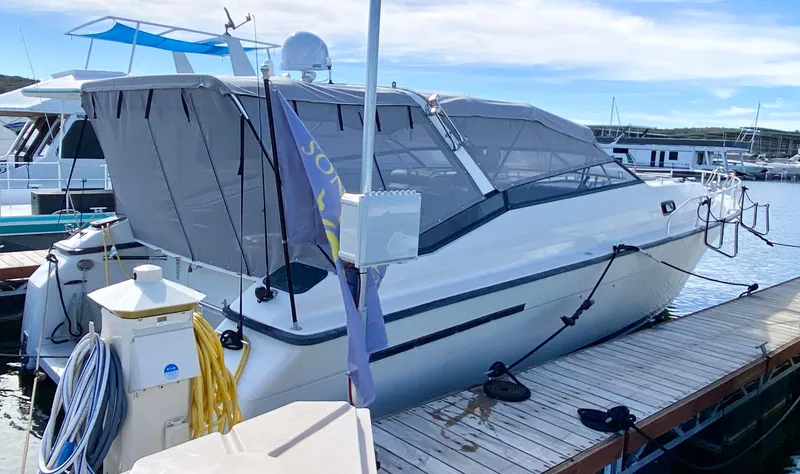 Slide: The Image of 1989 Mainship 39 Mediterranean Express docked at marina with protective cover. - 12