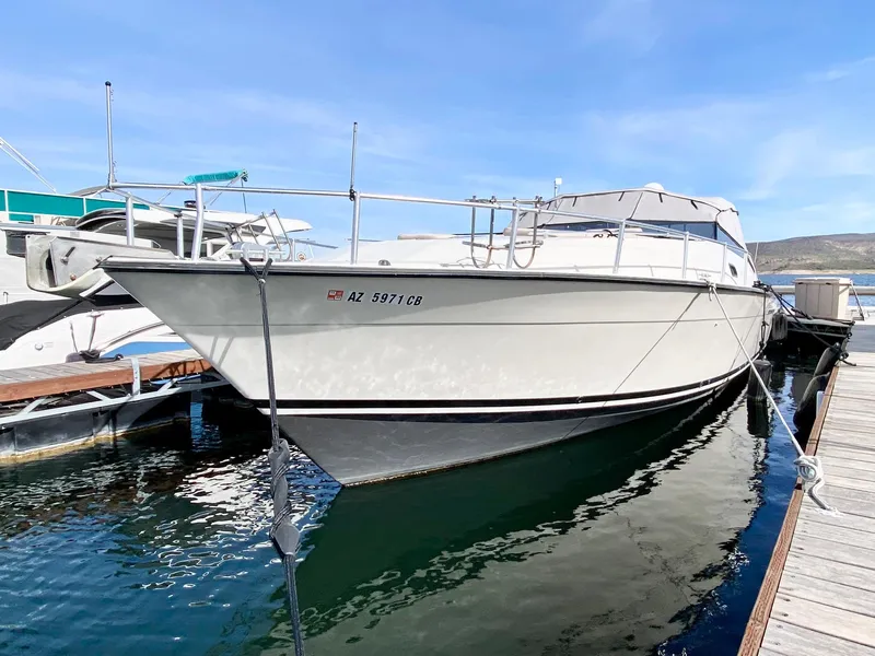 Slide: The Image of 1989 Mainship 39 Mediterranean Express docked at marina, side view. - 13