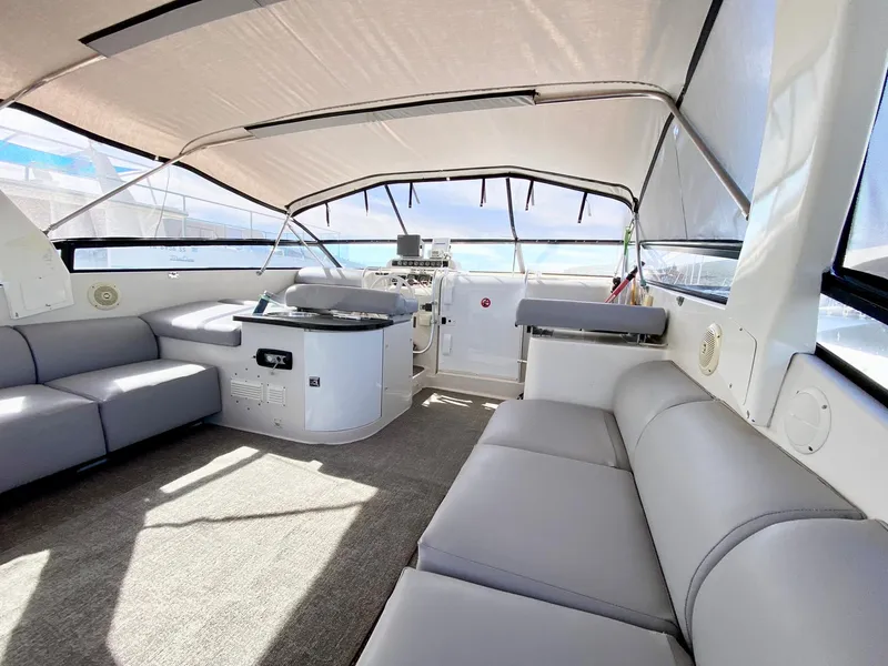 Slide: The Image of 1989 Mainship 39 Mediterranean Express interior with spacious seating and helm. - 16