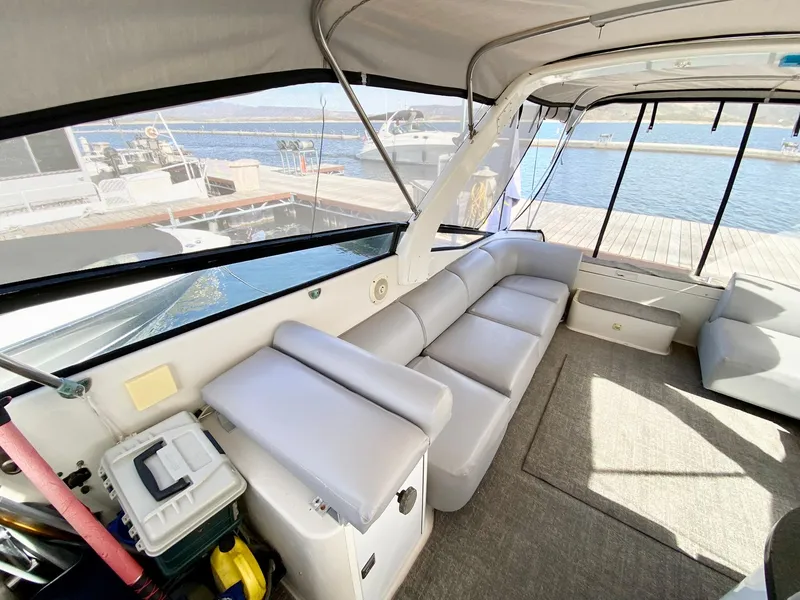Slide: The Image of 1989 Mainship 39 Mediterranean Express interior with spacious seating and waterfront view. - 19
