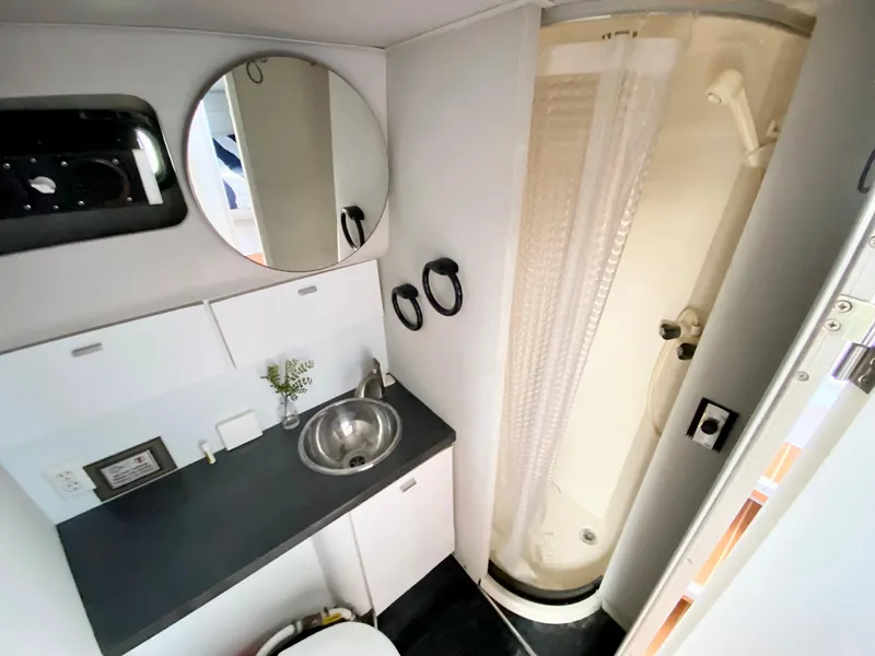 Slide: The Image of 1989 Mainship 39 Mediterranean Express bathroom with sink, shower, and mirror. - 21