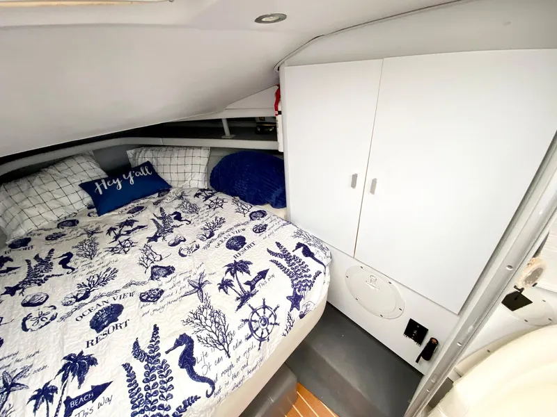 Slide: The Image of Cozy cabin interior of 1989 Mainship 39 Mediterranean Express with nautical-themed bedding. - 22