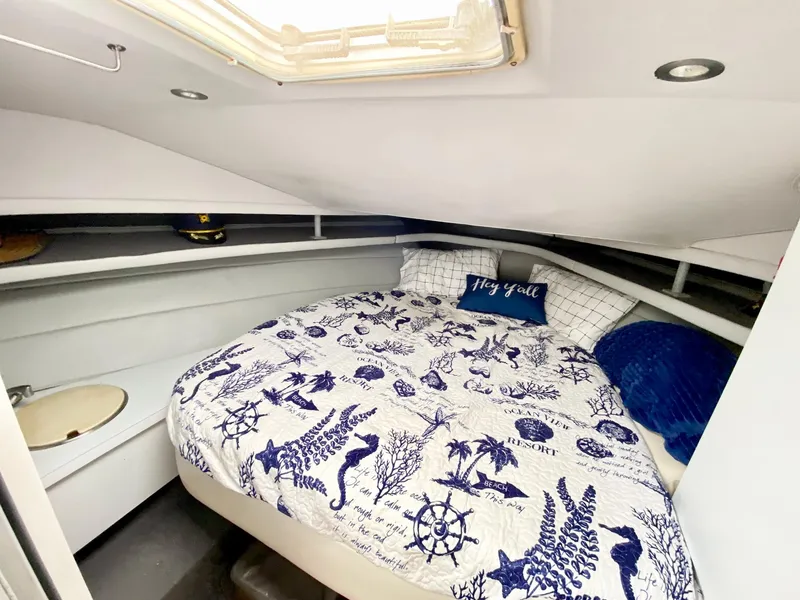 Slide: The Image of Cozy cabin interior of 1989 Mainship 39 Mediterranean Express with nautical-themed bedding. - 23