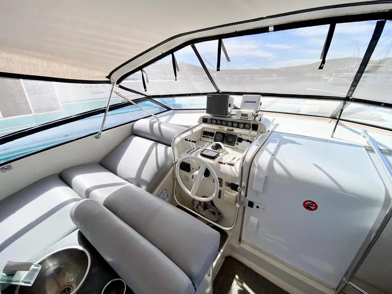 Slide: The Image of 1989 Mainship 39 Mediterranean Express boat interior with helm, seating, and navigation equipment. - 3