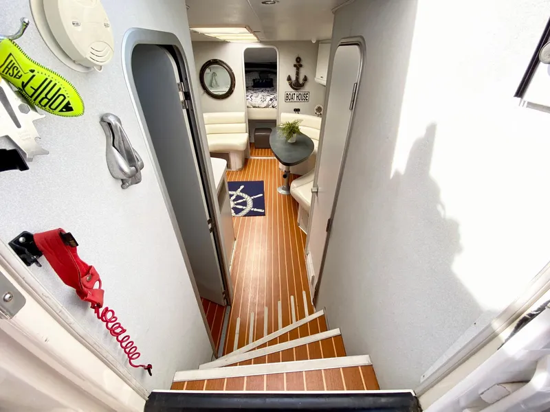 Slide: The Image of 1989 Mainship 39 Mediterranean Express interior with wood flooring and nautical decor. - 4