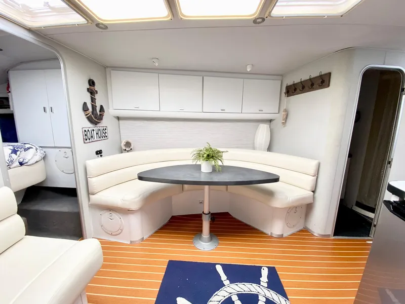 Slide: The Image of 1989 Mainship 39 Mediterranean Express interior with curved seating and nautical decor. - 7