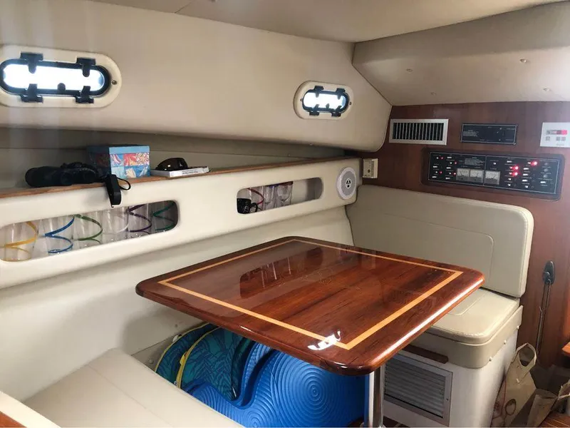 Slide: The Image of Interior of 2001 Pursuit 3000 Express boat with wooden table and seating area. - 11