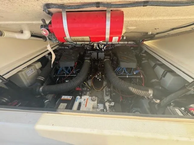 Slide: The Image of Engine compartment of a 2001 Pursuit 3000 Express boat with visible fire extinguisher. - 14