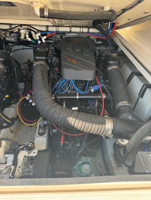 Slide: The Image of Engine compartment of a 2001 Pursuit 3000 Express boat, featuring a V8 engine. - 15