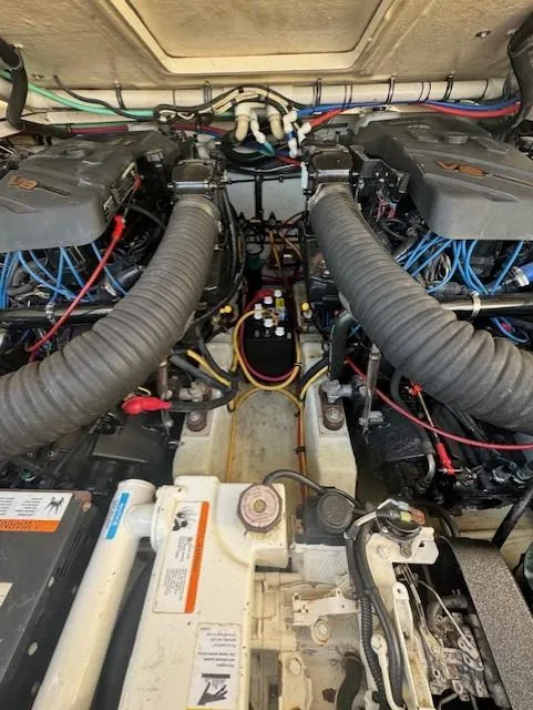 Slide: The Image of Engine compartment of a 2001 Pursuit 3000 Express boat, showcasing dual engines and wiring. - 17