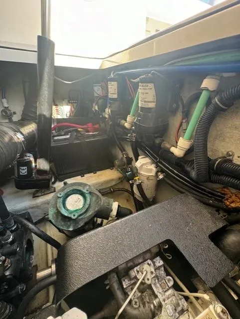 Slide: The Image of Engine compartment of a 2001 Pursuit 3000 Express boat, showcasing various mechanical components. - 18